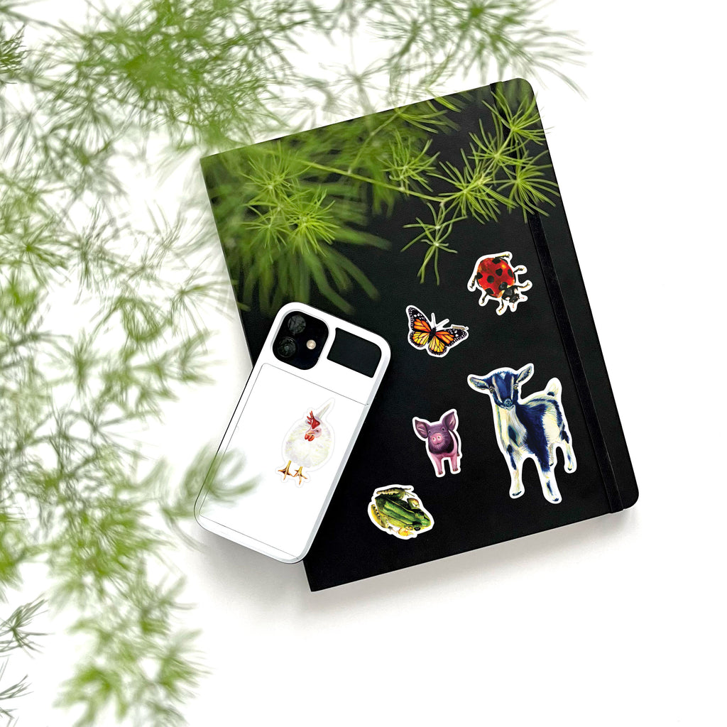 farm animal vinyl stickers on phone and notebook