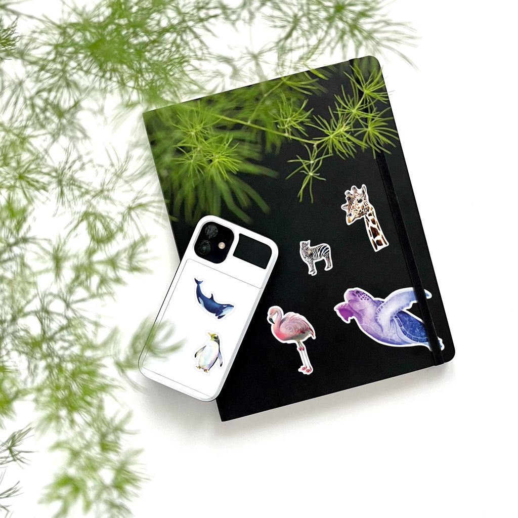 penguin, whale, flamingo, sea turtle, zebra and giraffe vinyl stickers on phone and notebook