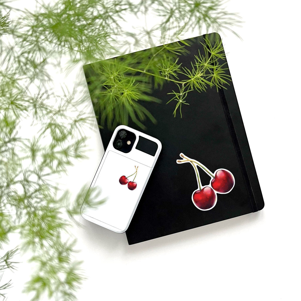 large and small red sweet cherry vinyl stickers on phone and notebook