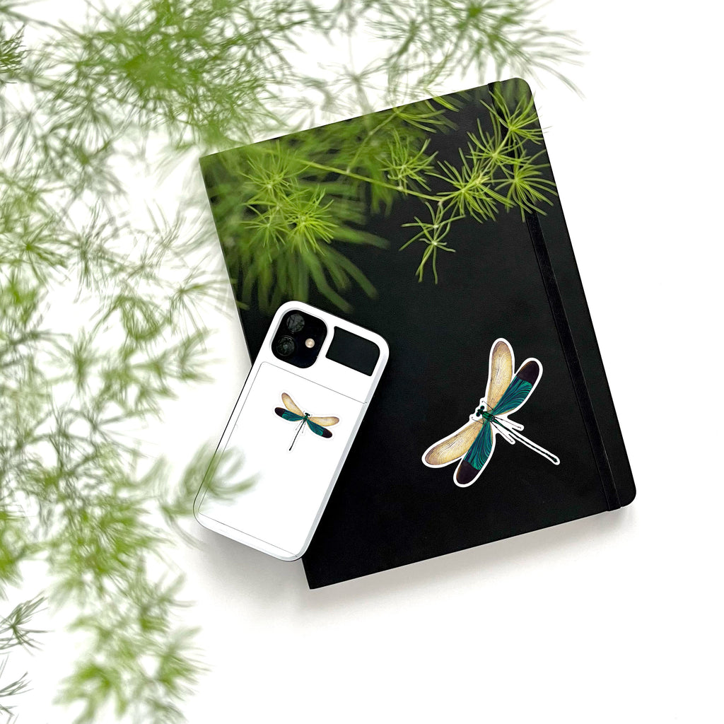 large and small blue dragonfly stickers on phone and notebook