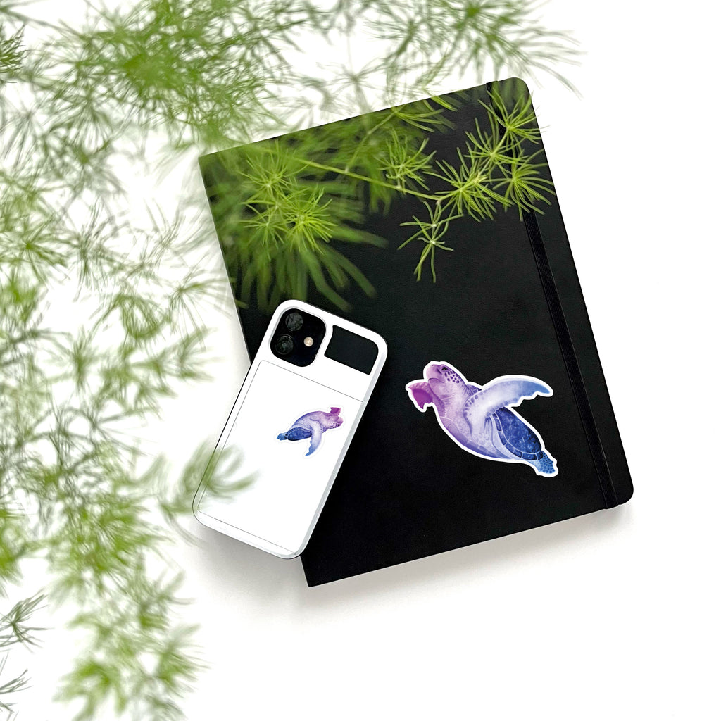 large and small purple sea turtle on phone and notebook