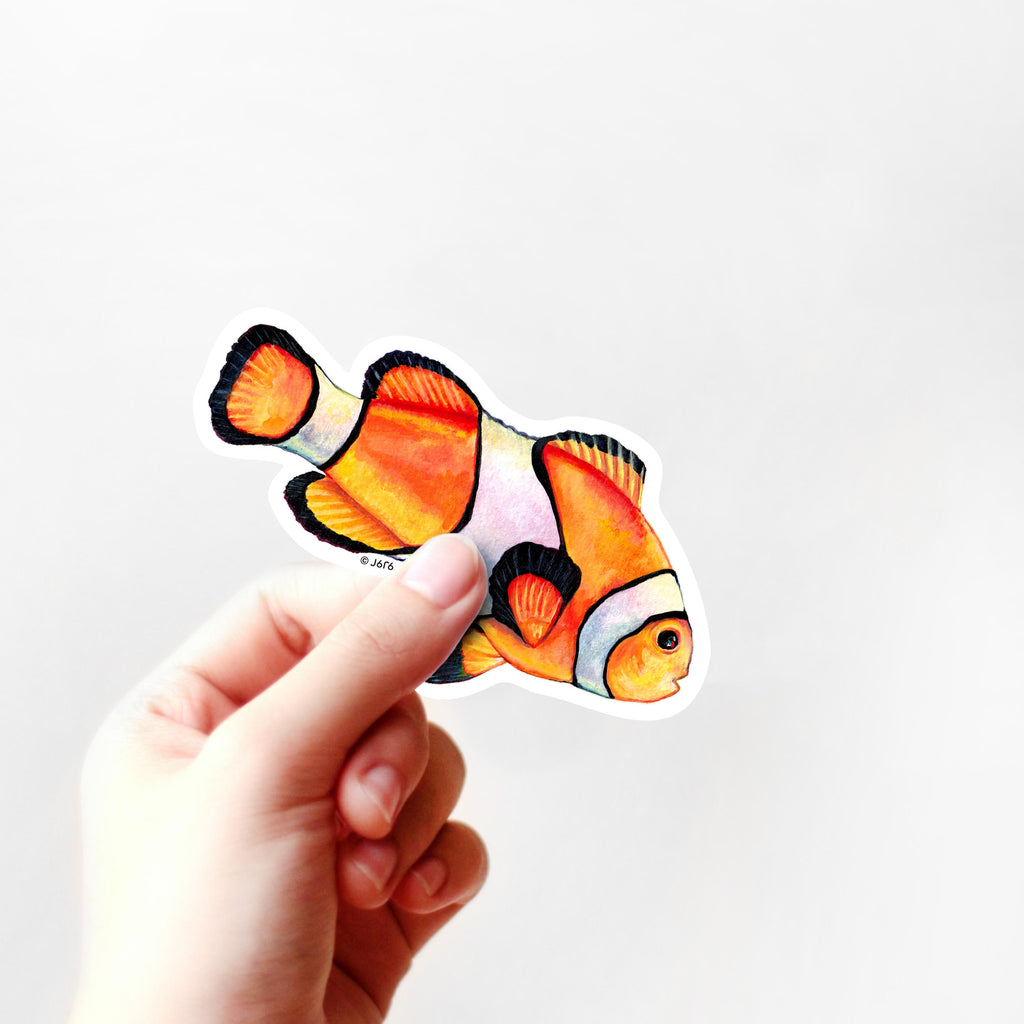 orange clownfish sticker in hand
