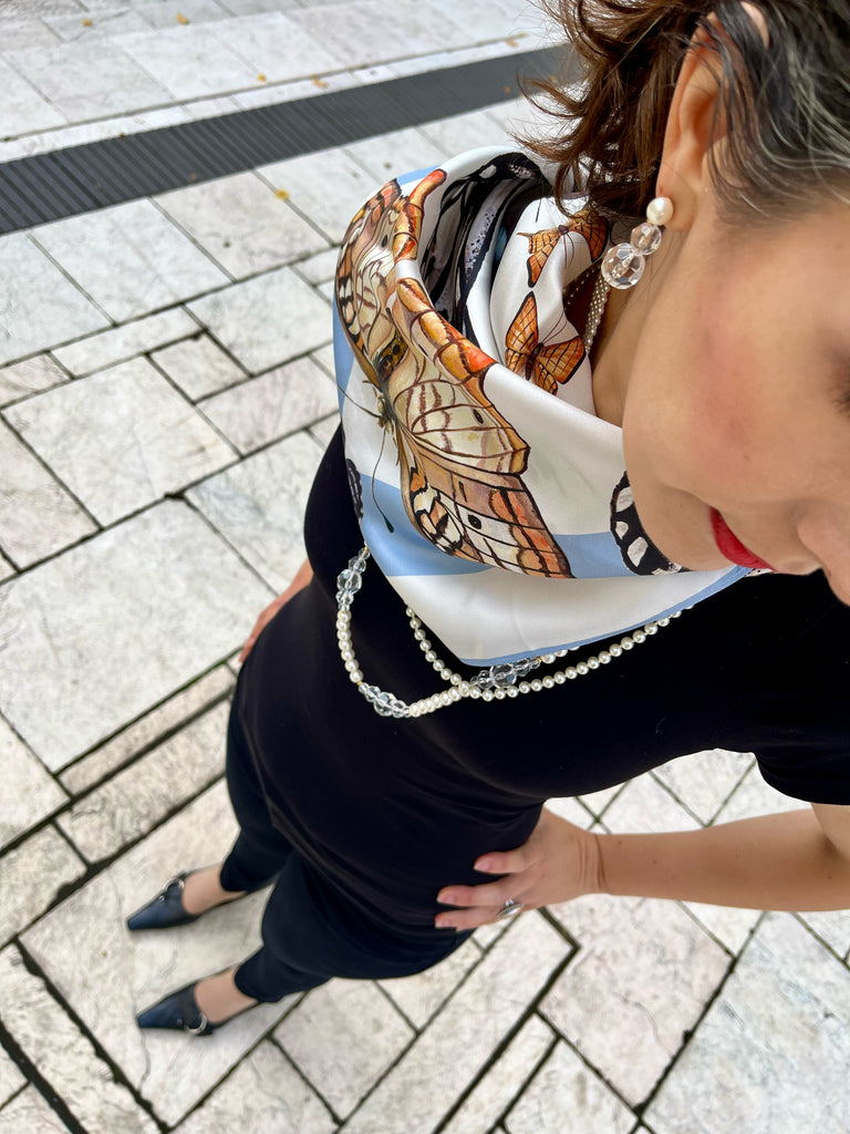 Orange, blue, and white Butterfly scarf on Model's Neck