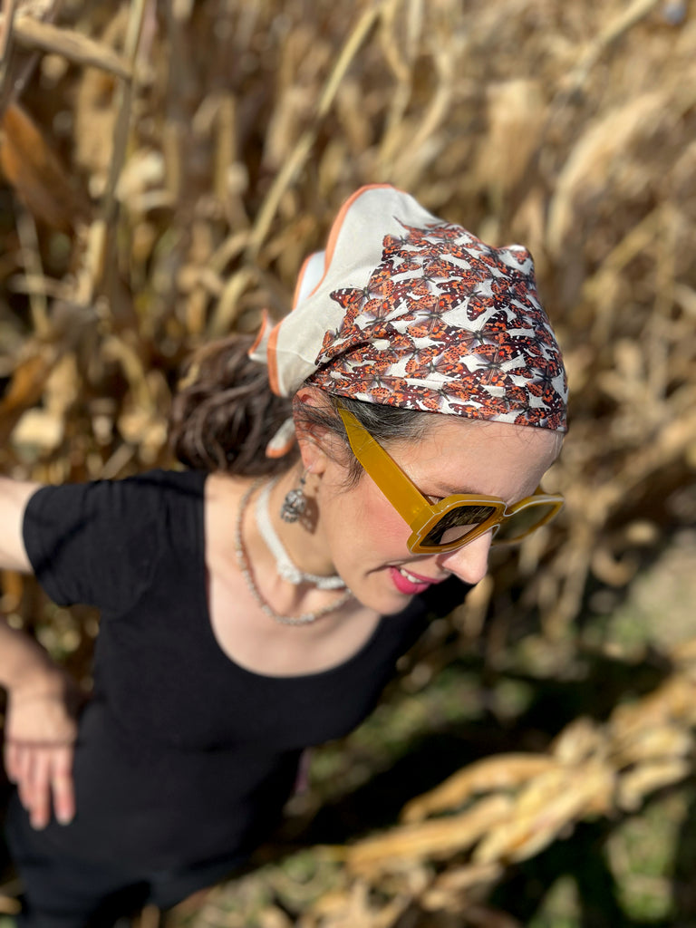 Peach and beige butterfly bandana on model's head