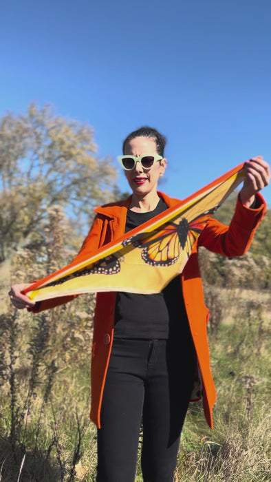 model showing multiple ways to wear the monarch butterfly silk scarf to create different looking scarfs.