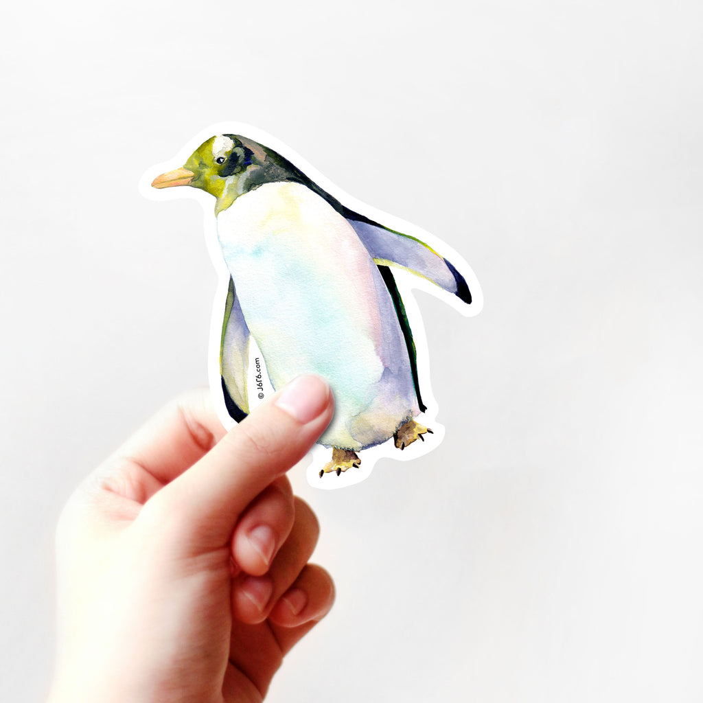 green and blue penguin sticker with hand