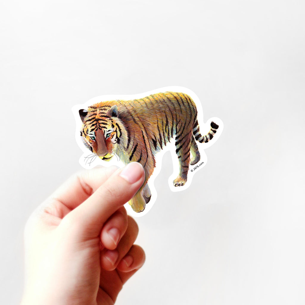 orange tiger sticker in hand