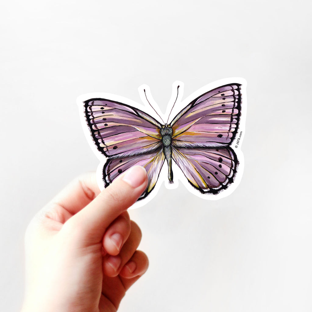 purple butterfly vinyl sticker in hand