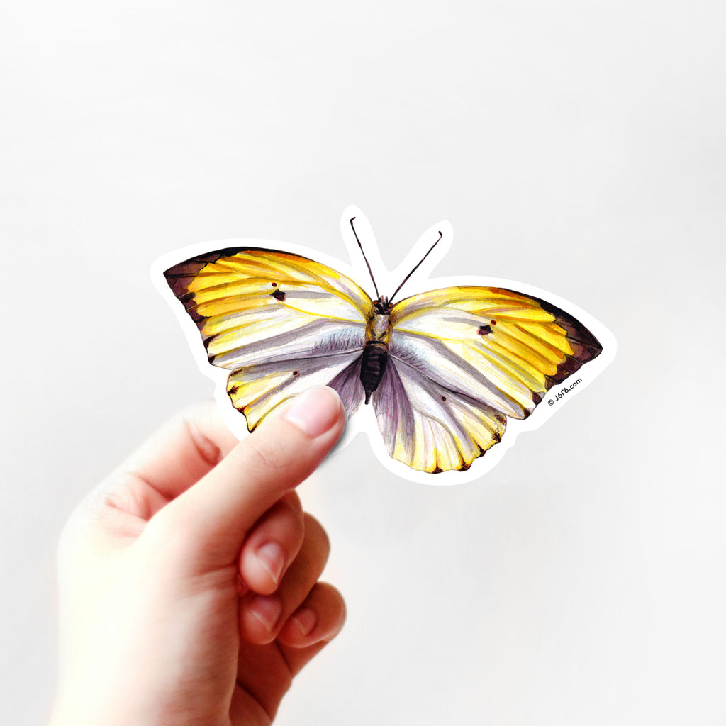 yellow butterfly vinyl sticker in hand